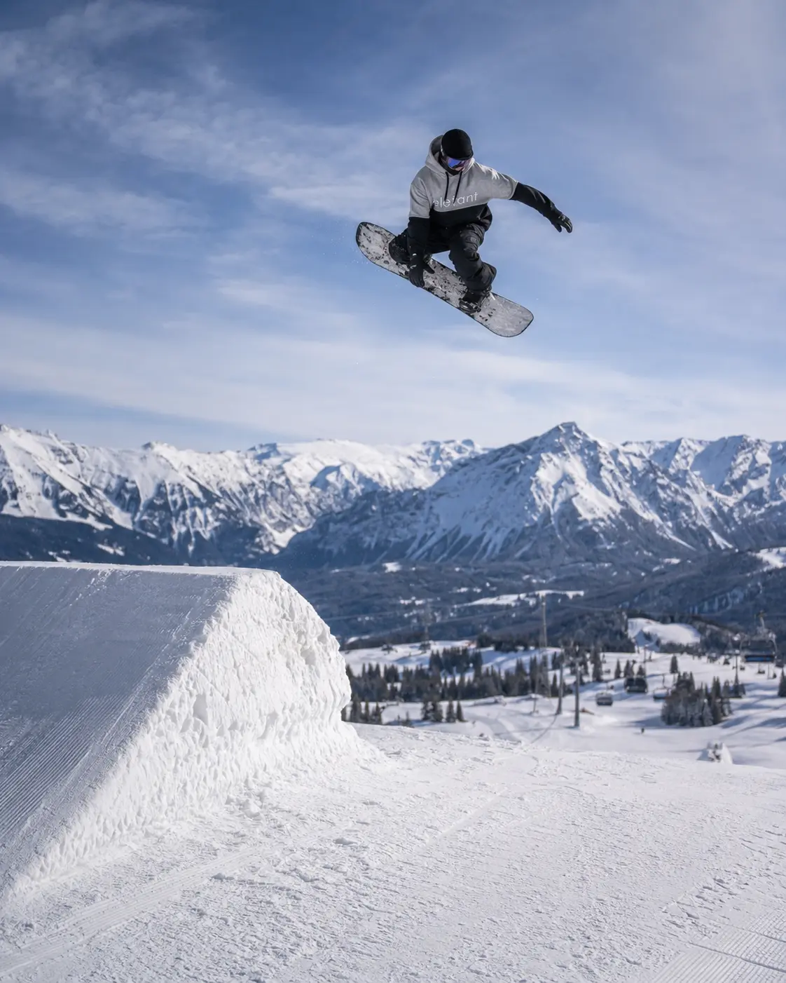 Elefant rider boosting a park jump in a tall hoodie